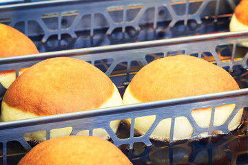 Poster - Frying donuts in oiled pans.