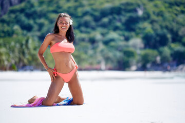 Wall Mural - Sexy girl in red swimsuit enjoying at the tropical beach