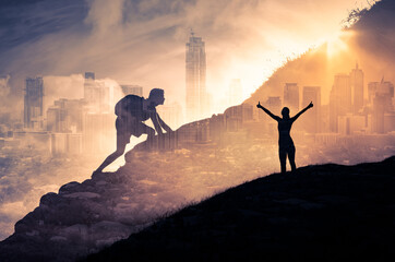 silhouette of a person climbing to the top of a mountain. female with arms up to the sky. strong man