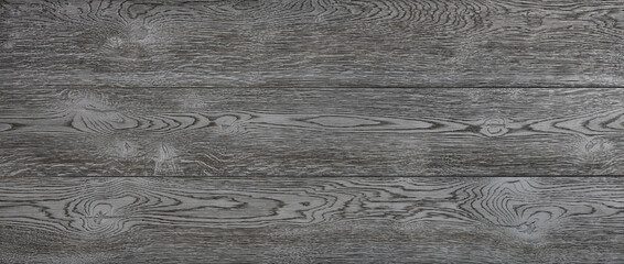 Expressive texture of black wood planks with longitudinal grains and knots.