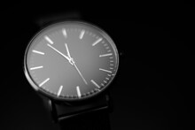Black Modern Analog Wristwatch On A Black Background