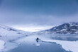 © Josu Torrealday/ADDICTIVE STOCK - Back view of traveling friends in outerwear and with paddles floating in canoe along river in winter in snowy mountains in Norway