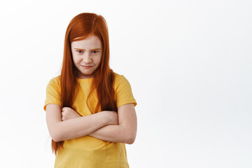 Wall Mural - Cute sulking little girl with ginger hair and freckles cross arms on chest, upset about unfair thing, pouting and acting childish, want something, white background