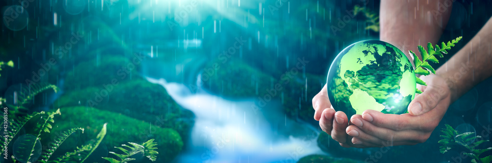 Hands Holding Crystal Earth In Tropical Rainforest With Waterfall Mossy Rocks And Rain - Rainforest Preservation Concept - obrazy, fototapety, plakaty 