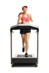 Canvas Print - Young woman smiling and running on a treadmill