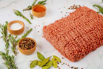 Wall Mural - Fresh ground beef with spices, rosemary and bay leaf.