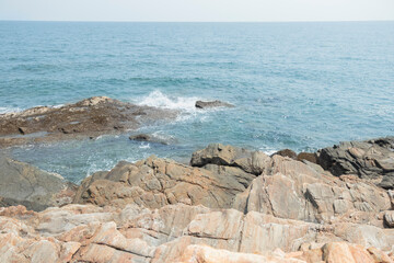 Rocks on the beach are rocks and brown wooden bridges along the hillsides, rocky mountains and sea close to island, eco-tourism concept