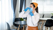 © Freedomz - Asian woman waitress wearing face mask and medical glove to prevent and stop coronavirus before working