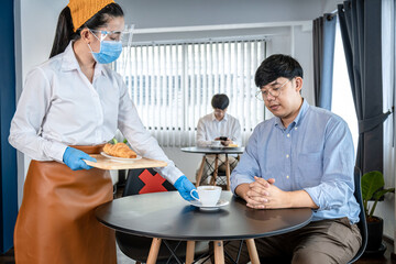 Aufkleber - Asian woman waitress serving coffee and bread to client while wearing face mask and face shield