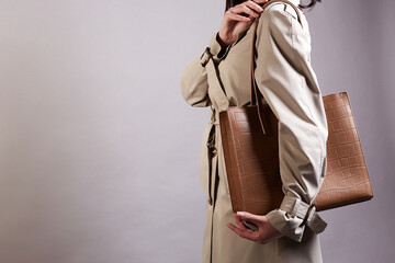 young woman in trendy trench coat and bag