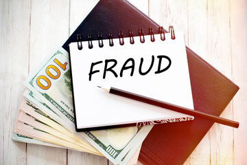 Poster - FRAUD text written on notebook with dollar bills and pencil