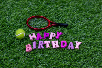 Wall Mural - Happy birthday to Tennis player with tennis ball on green grass