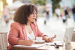 © liderina - Business woman sitting in café and using laptop.