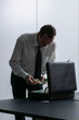 © fStop - Businessman counting money at briefcase in office