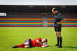 © fStop - Soccer coach watching player sleeping on ball on sunny pitch
