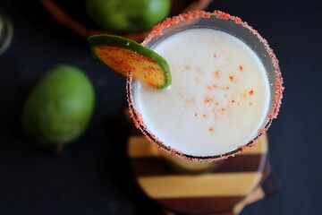 Indian traditional sweet green mango juice. Also known as Aam Panna, Ambyache Panha. Summer Refreshing drink made with raw mangos, jaggery, and salt. Recipe ingredients with copy space.