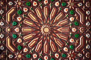 Close up of colored ornament on wood in traditional islamic style.