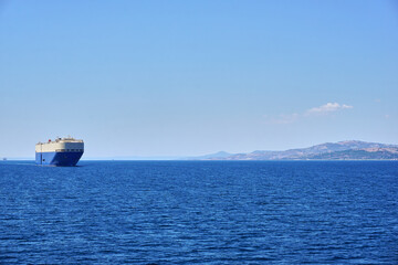 Big cargo ship crossing the strait