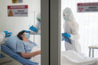 © Waranya - Doctors in the protective suits examined a infected patient in the control area. Coronavirus COVID 19 quarantine area.