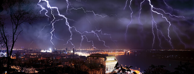 Wall Mural - dark cloudy sky with lightning over city, banner design. stormy weather