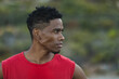 © Wavebreak Media - Portrait of fit african american man exercising outdoors looking to a side on a coastal road