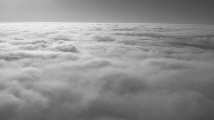Wall Mural - view from flying high in heaven airplane. sunny peaceful fluffy white clouds and blue sky with horiz
