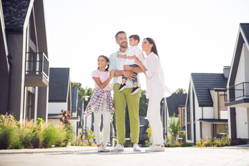 Sticker - Full length body size view of four cheery family embracing youth kids move new life home investment leasing rent in cottage town outdoor