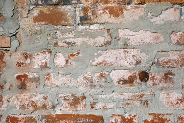 Old brick wall with cement, texture. Cement grunge wall close up..Vintage old red brick wall background. Concrete, stone pattern.