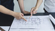 © Puwasit Inyavileart - Meeting of engineers and architects in building planning, Consulting and brainstorming experts in architectural planning using blueprints, tape measure, rulers, laptop in designing buildings.