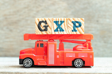 Poster - Fire ladder truck hold letter block in word GXP on wood background