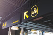 © Rokas - Airport informaction signs. Arrow on information screen leading to security check