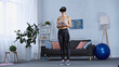 © LIGHTFIELD STUDIOS - young woman in sportswear and vr headset standing in modern living room