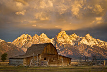 The Moulton Barn On Mormon Row Stands Before A Fiery Sunrise On The Teton Mountains In Grand Teton National Park, Wyoming.    
