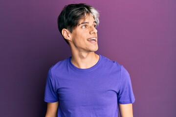 Poster - Young hispanic man wearing casual clothes looking to side, relax profile pose with natural face and confident smile.