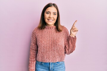 Poster - Young beautiful woman wearing casual clothes smiling with an idea or question pointing finger up with happy face, number one