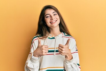 Poster - Young caucasian woman wearing casual clothes success sign doing positive gesture with hand, thumbs up smiling and happy. cheerful expression and winner gesture.