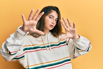 Sticker - Young caucasian woman wearing casual clothes doing frame using hands palms and fingers, camera perspective