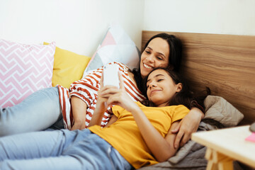 Wall Mural - Single parenthood. Mother and daughter spending time together at home.