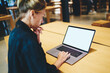© BullRun - Female freelancer checking program text on blank laptop computer with copy space area for internet advertising, woman connecting to coworking wireless for browsing web page on mockup netbook