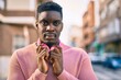 © Krakenimages.com - Young african american man with serious expression using headphones at the city.