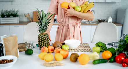 Canvas Print - Vegan natural fresh ingredients for salad. Attractive female with fresh vitamin fruits and vegetables.