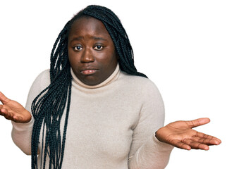 Poster - Young black woman with braids wearing casual winter sweater clueless and confused expression with arms and hands raised. doubt concept.