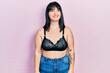 © Krakenimages.com - Young hispanic woman wearing lingerie looking away to side with smile on face, natural expression. laughing confident.