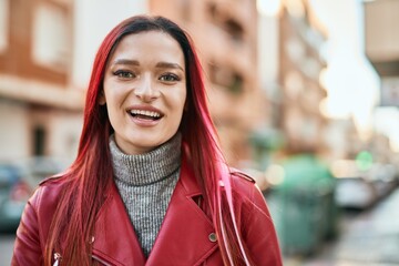 Young caucasian girl smiling happy standing at the city.