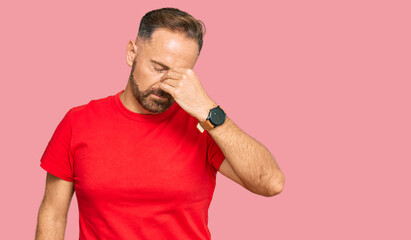 Sticker - Handsome middle age man wearing casual red tshirt tired rubbing nose and eyes feeling fatigue and headache. stress and frustration concept.