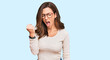 © Krakenimages.com - Young brunette woman wearing casual clothes and glasses angry and mad raising fist frustrated and furious while shouting with anger. rage and aggressive concept.