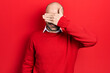 © Krakenimages.com - Young bald man wearing casual clothes and glasses smiling and laughing with hand on face covering eyes for surprise. blind concept.