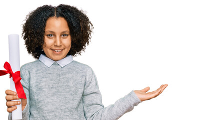 Sticker - Young little girl with afro hair holding graduate degree diploma celebrating victory with happy smile and winner expression with raised hands