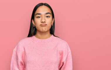 Canvas Print - Young asian woman wearing casual winter sweater looking sleepy and tired, exhausted for fatigue and hangover, lazy eyes in the morning.