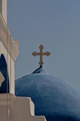 Wall Mural - A religious cross and a bell at the top of an orthodox chapel in Ios Greece